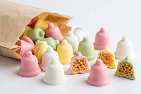 Pastel candy-coated Cadbury Clinkers chocolates spilling from a bag